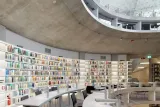 An image of a library filled with an extensive collection of books organized on shelves.