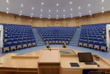 University of Pardubice auditorium, showcasing rows of seats and a stage for academic events and lectures.